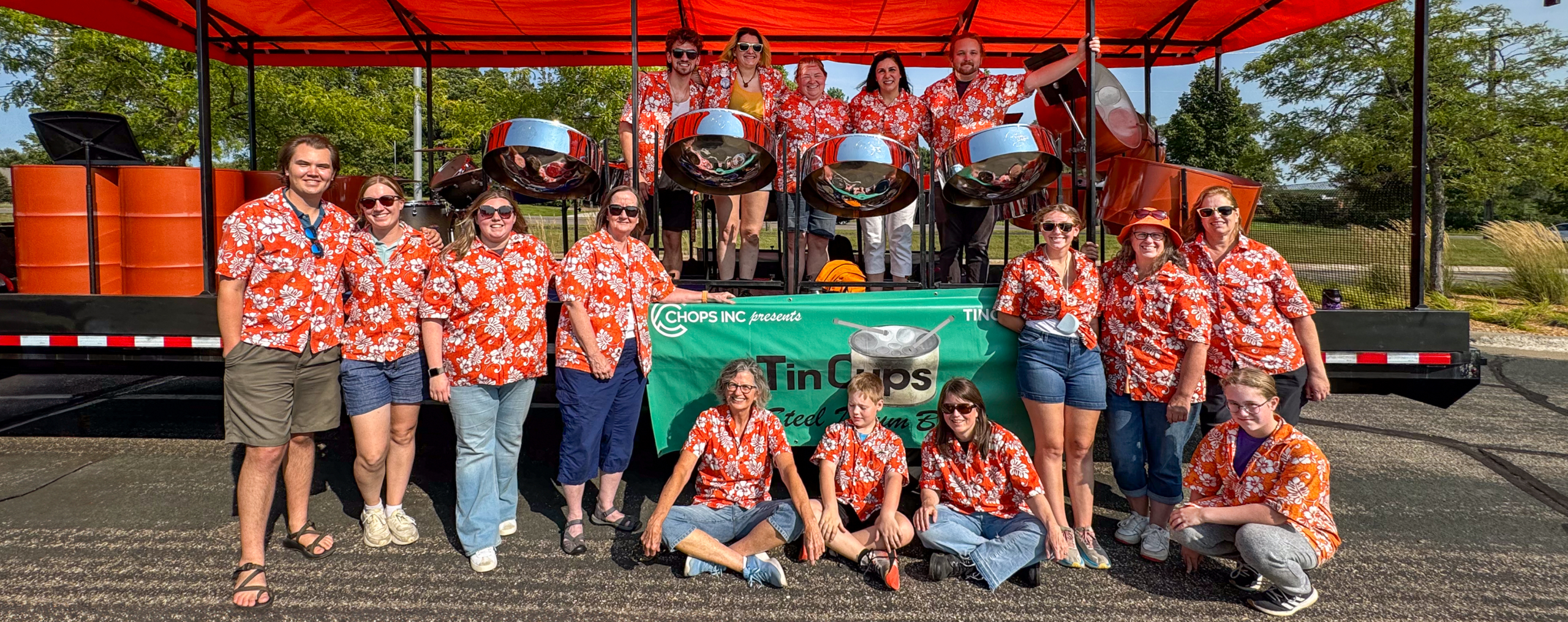 Tin Cups community steel drum band performing in a Twin Cities summer parade. Free, all-age ensemble playing steel pan music.